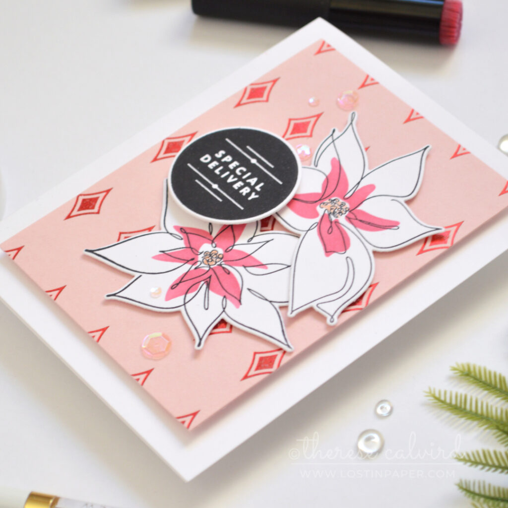 Pink Christmas card with a red hot foiled diamond background and layered bells