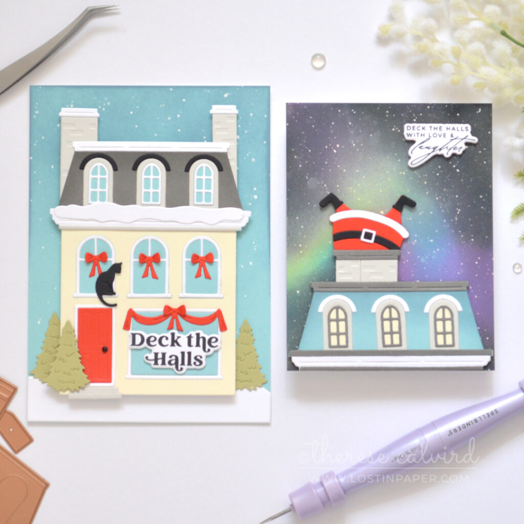 Cream City House Christmas card with grey Mansard roof, bright red door, snowy details, red window garlands and a black cat.