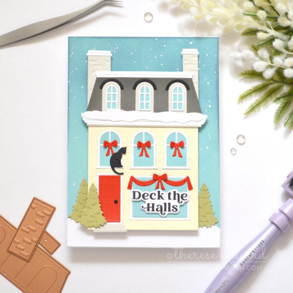 Cream City House Christmas card with grey Mansard roof, bright red door, snowy details, red window garlands and a black cat.