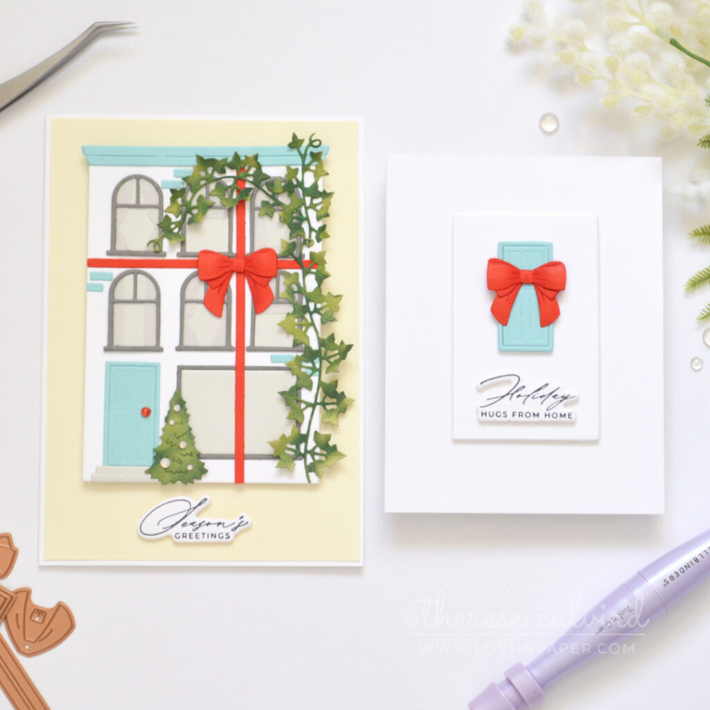 White City House Christmas card with blue roof and door, red bow, green vine, Christmas tree and vellum curtains.