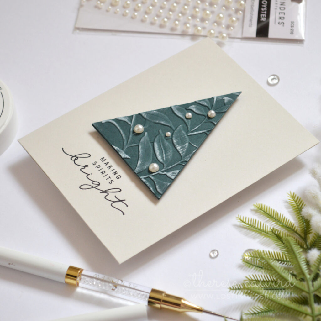 Modern Christmas card with an embossed foliage triangle tree and pearl accents.