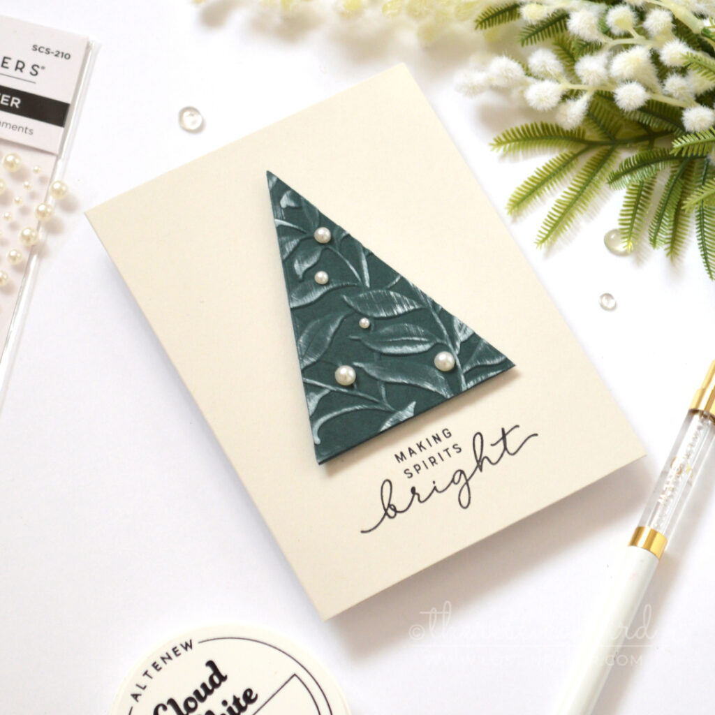 Modern Christmas card with an embossed foliage triangle tree and pearl accents.