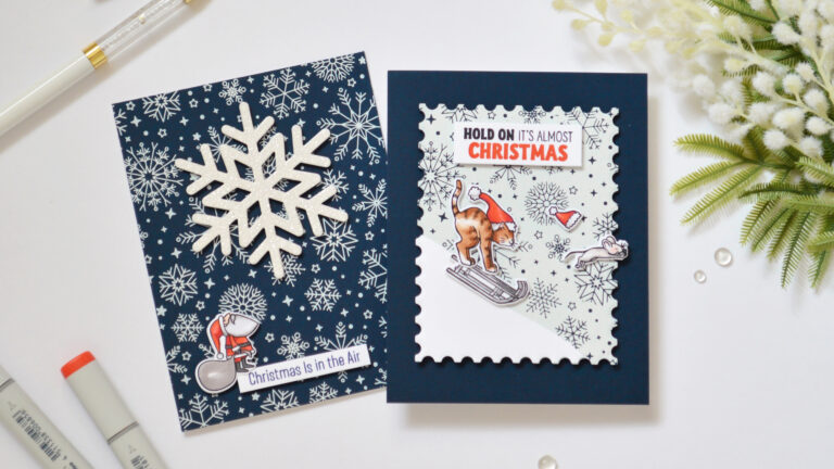 Two handmade cards created with Spellbinders Glimmer II hot foiling, featuring two navy snowflake Christmas cards